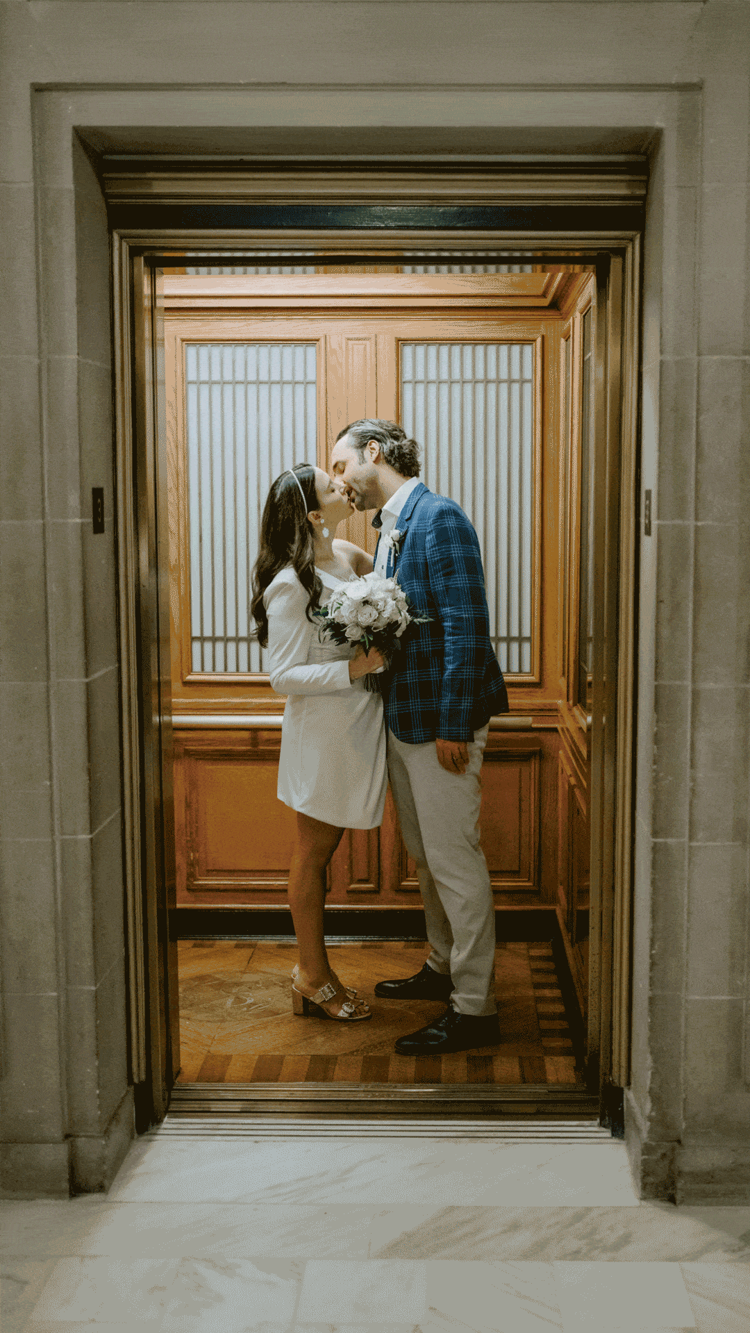 Classic San Francisco City Hall elevator of couple kissing