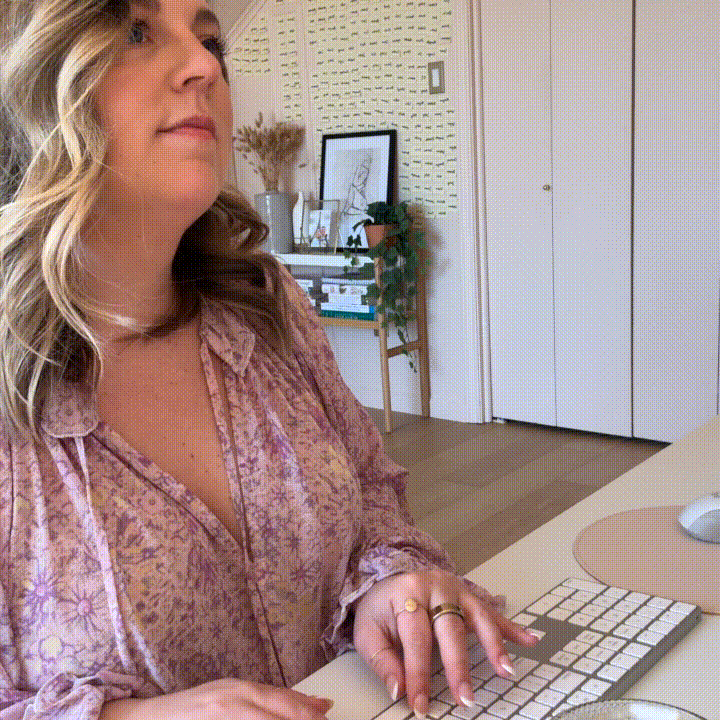 GIF of Mollie Mason in a purple dress typing on her keyboard