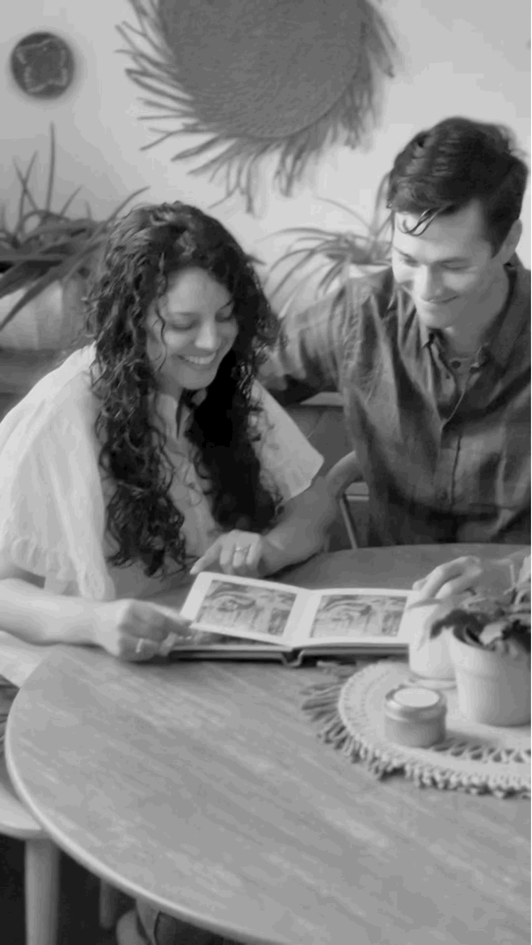 Gif of smiling couple looking at wedding album