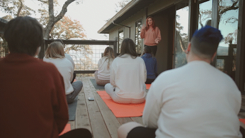 moving GIF of a group of girls doing yoga on a patio