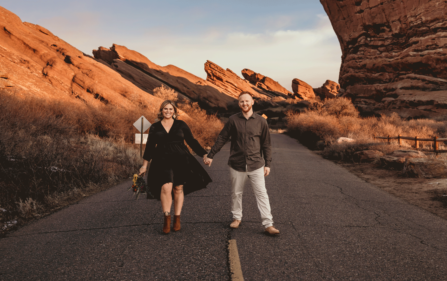 Wedding and elopement photography, man and woman walk down road at red rocks park during sunrise