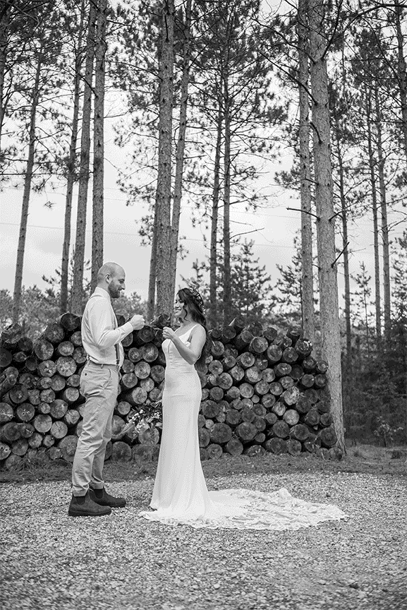 Bride and groom kissing in forest