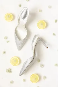 Sparkling bridal heels styled with lemon slices in a bright flat lay