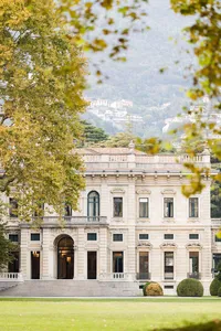 Historic villa wedding venue framed by autumn trees and mountains