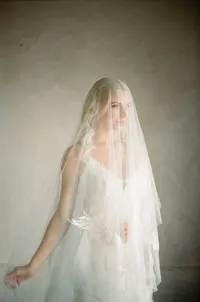 Film photograph of a bride wrapped in her veil