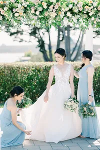 Romantic coastal wedding ceremony in Half Moon Bay, California, featuring a bride and groom with stunning ocean views, sandy beaches, dramatic cliffs, and picturesque sunset skies.