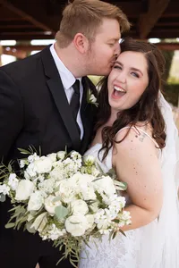 Close-up of the bride holding her white rose bouquet