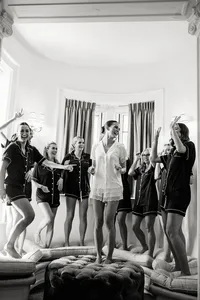 A candid, documentary style wedding photography moment of a bride and her bridesmaids celebrating, preserving the atmosphere and emotion of the morning.