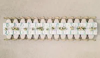 Symmetrical aerial photograph of a long, luxury outdoor reception table with pastel floral arrangements at Chateau de Tourreau in France.