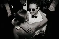 An editorial black and white capture of a couple dancing at their reception, showcasing a genuine connection and the natural unfolding of the night.