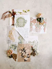 A sophisticated flat lay of an heirloom invitation suite and accessories, reflecting the intentional imagery of a luxury wedding.