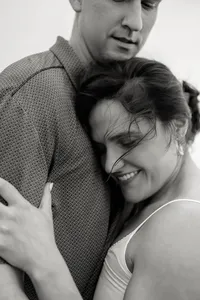 An intimate, close-up moment of a couple embracing, illustrating the natural unfolding of emotion during a Charleston wedding weekend.