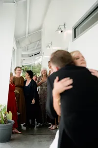 A poignant in-between moment of a bride being embraced by her father, focusing on preserving atmosphere and emotion over posed shots.