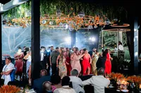 Guests fill the dance floor beneath hanging greenery and glowing ring lights as music plays late into the evening in Antigua Guatemala wedding.