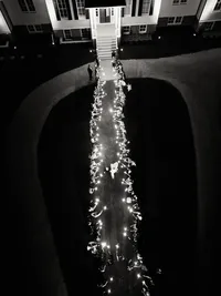 An artistic top-down view of a sparkler exit at a waterfront wedding, showcasing refined composition and intentional imagery.