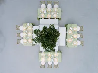 A precise top-down view of reception tables featuring sage linens and gold accents, highlighting the refined composition of a multi-day wedding celebration.