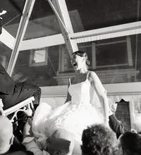 High-energy documentary wedding photography capturing the Horah dance under a clear-top tent at Chatham Bars Inn.