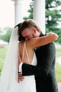 An intimate, close-up moment of a couple embracing after their first look, illustrating the natural unfolding of emotion during a wedding weekend.