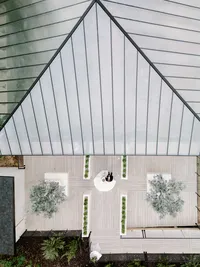 A striking overhead view of a modern glass-roofed wedding venue, highlighting refined composition and intentional imagery from a unique perspective.