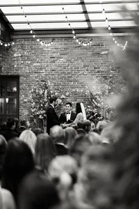 A black and white view of a wedding ceremony at Wythe Hotel, preserving the atmosphere and emotion of an intentional Brooklyn celebration.
