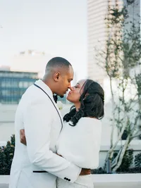 Bride and groom portrait with Dallas skyline at The Thompson Hotel