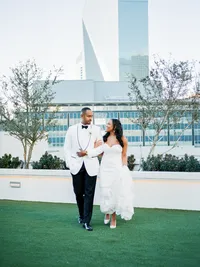 Bride and groom portrait with Dallas skyline at The Thompson Hotel