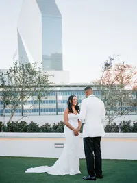 Bride and groom portraits at The Thompson Hotel Dallas with city skyline views