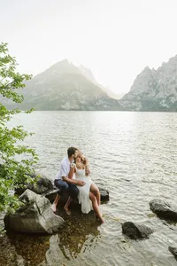 Couple sits romantically admiring Jenny Lake