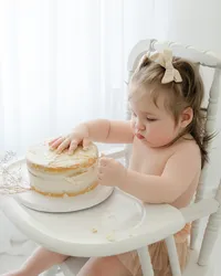 Baby with cake during milestone session with Niceville family photographer