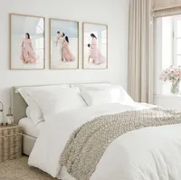 Three framed Destin beach portraits of a mother and child displayed as a gallery wall above a bed