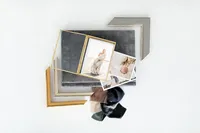 Linen-bound portrait albums and fabric swatches displayed on a light backdrop