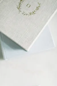 Linen album with custom gold foil crest for personalized portrait keepsakes