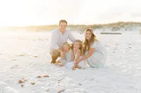 Family of four at beach during professional Niceville family photographer session