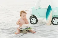 Family on beach with vintage truck captured by Niceville family photographer