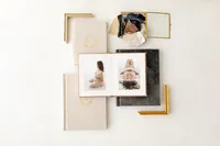Open heirloom portrait album showing studio session photos from Andrea Krey Photography in Niceville, Florida