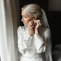 superherodesignco_34572_bride_getting_ready_near_a_bright_win_425622ac-f208-41b1-a470-767d147ece4b_1