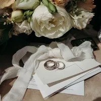 superherodesignco_34572_flatlay_of_wedding_rings_bridal_bouqu_fab005a0-e24e-4b82-aea5-3d7cad1d7868_3