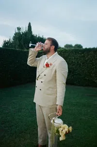 Groom sips wine in Europe