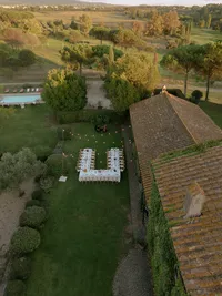 Drone shot of a reception table with string lights above