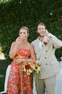 Destination wedding couple sipping champagne together