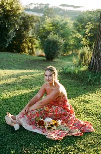 Bride poses in Europe wearing a colorful floral dress