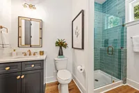 bathroom with blue tile shower