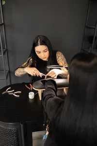 Professional brow artist focusing with magnifying lamp during client procedure. Photograph by Yucaipa branding photographer Kaitlyn Dawn Photography.