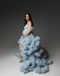 Expecting mom standing in a flowing blue maternity dress with a dramatic train, showcasing her pregnancy in the Inland Empire by Kaitlyn Dawn Photography.