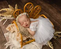 Newborn baby posed in a rustic basket with pink layers and soft textures. Photographed by Inland Empire newborn photographer Kaitlyn Dawn Photography.