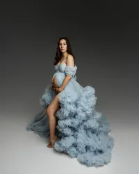 Expecting mom in a flowing blue maternity gown posing with her baby bump, captured by Kaitlyn Dawn Photography in the Inland Empire.
