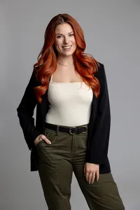 Studio branding portrait of woman with red hair looking at reflection in mirror. Photograph by Yucaipa branding photographer Kaitlyn Dawn Photography.