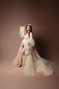 Elegant maternity portrait of an expecting mother wearing a crown and champagne maternity gown during a studio session captured by Yucaipa maternity photographer Kaitlyn Dawn Photography.