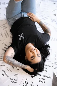 Professional beauty artist laughing while reclining on floor during branding photos. Photograph by Yucaipa branding photographer Kaitlyn Dawn Photography