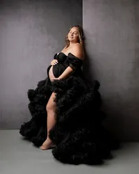 Pregnant woman wearing an elegant black tulle maternity gown during a studio maternity photography session by Kaitlyn Dawn Photography.